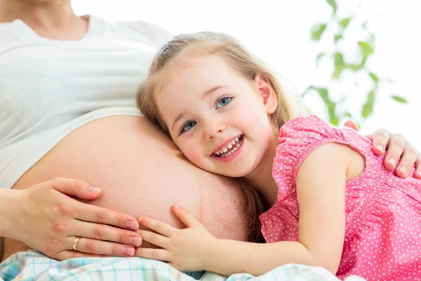 Счастливый парень девушка обнимать живот беременной матери — стоковое фото