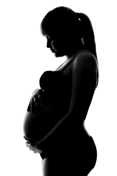 Беременная девушка в нижнем белье в профиль — стоковое фото