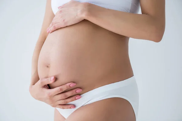Касаясь живот беременной женщины — стоковое фото