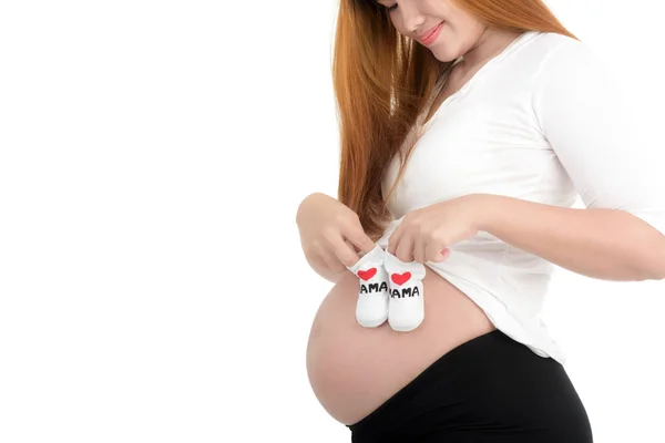 Беременные женщины и малых обувь для нерожденного ребенка — стоковое фото