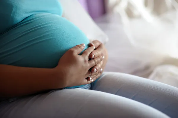 Молодая мать беременный живот — стоковое фото